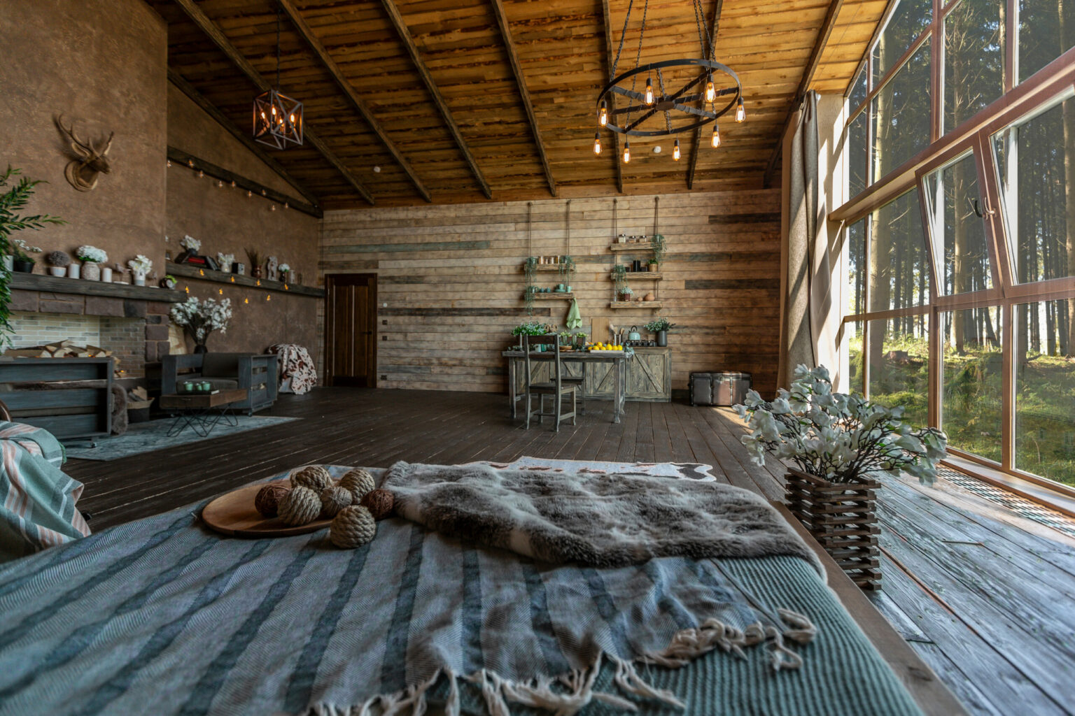 dark cozy interior of big country wooden house, wooden furniture and animal furs. huge panoramic window and very high ceiling.